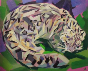 Snow Leopard lieing down in the bush